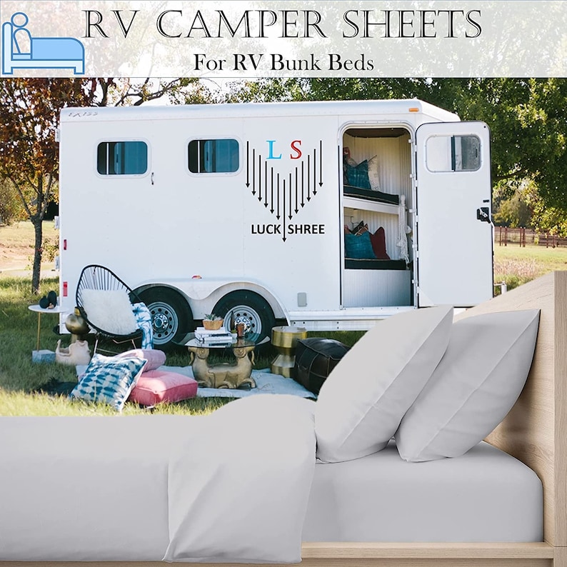 May include: White RV camper with bunk beds and the text "RV CAMPER SHEETS For RV Bunk Beds" on the side. The camper is parked in a grassy area with a white bed with two pillows in the foreground.
