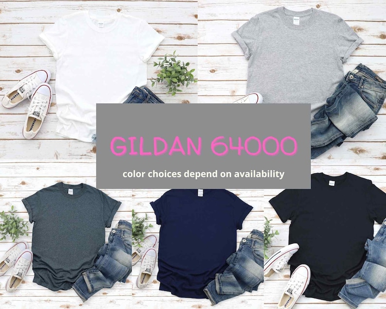 May include: Five blank Gildan 64000 t-shirts in different colors: white, heather gray, dark heather, navy blue, and black. Each shirt is folded and placed on a wooden surface with a pair of jeans.