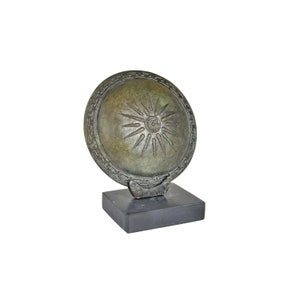Bronze Vergina Sun Shield on a Marble Base – Symbol of Royal Macedon in Ancient Greece,Vergina Sun 16‑rayed star meaning museum replica