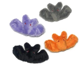 May include: Four plush bat toys in various colors: purple, gray, orange, and black. Each bat has red embroidered eyes. The toys are designed with outstretched wings and a soft, fuzzy texture.