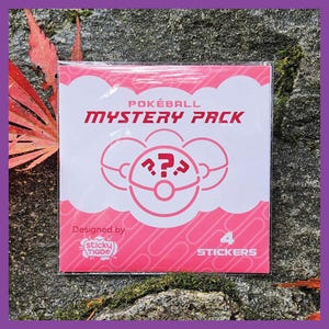 May include: A pink and white sticker pack with a Pokéball design. The pack says "Pokéball Mystery Pack" and features a Pokéball with a question mark inside. The pack also says "Designed by Sticky "nabe" and "4 Stickers".