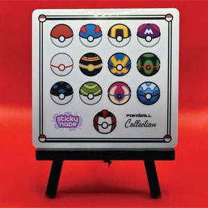 May include: A white square sticker sheet with 15 colorful Pokeball designs. The sheet is on a small black easel. The text "sticky nade" and "POKEBALL Collection" is printed on the sheet.