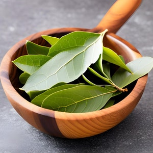 May include: A wooden bowl filled with fresh green bay leaves.