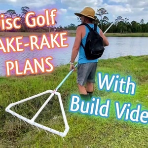 May include: A person uses a DIY disc golf lake rake to retrieve a lost disc from a pond. The rake is made of white PVC pipe and has a long handle. The text "Disc Golf LAKE-RAKE PLANS With Build Video" is superimposed on the image.