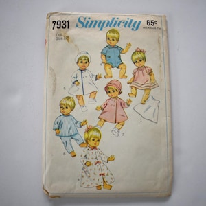 May include: Vintage Simplicity sewing pattern 7931 for a 12-inch doll. The cover features illustrations of dolls in various outfits, including a blue romper, pink dress, and a white coat. The pattern is marked with the price of 65¢.