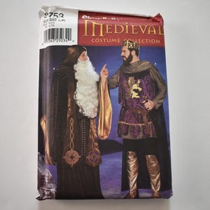 May include: A Simplicity 9753 sewing pattern envelope for a Medieval Costume Collection. The front shows two figures in historical-style outfits: one in a dark robe with a long white beard, and one in a purple and gold tunic with a crown.