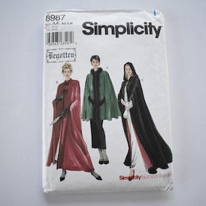 May include: Simplicity sewing pattern featuring three different cloak designs. The pattern envelope shows illustrations of the cloaks in red, green, and black. The pattern includes the text "Begotten" and "Simplicity fashion Trims".