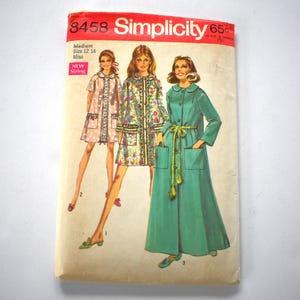 May include: Vintage Simplicity sewing pattern envelope. The envelope features illustrations of three different coat designs. The envelope is labeled "3458 Simplicity" with the size information "Medium Size 12 14 Miss". The envelope has a red and white color scheme.