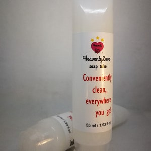 Puede incluir: Tubo de jabón blanco de plástico con texto rojo que dice "Heavenly Love soap tube Conveniently clean, everywhere you go! 55 ml / 1.93 fl oz".