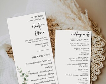 May include: Wedding ceremony program with a green eucalyptus illustration and the text "Welcome to the wedding of Austynn + Oliver" and "Saturday, October 29, 2022 5:00 o'clock in the evening Honalee Farms Eagle, ID". The program lists the ceremony order: Prelude, Processional, Readings, Exchange of Wedding Vows, Exchange of Rings, Announcement of Marriage, Presentation of Bride & Groom, Recessional.