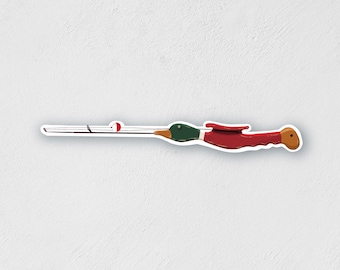 May include: A red and green wooden fishing rod with a duck head handle and a red and white bobber.