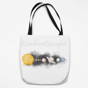 May include: A white tote bag with black handles featuring a watercolour illustration of the solar system with the text "Rainbow Designs" printed on the front.
