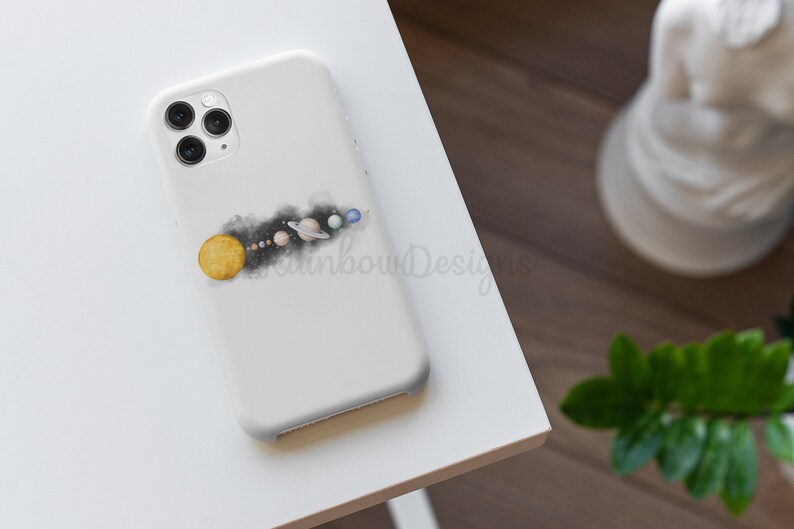 May include: White phone case featuring a watercolour illustration of the solar system. The sun is yellow, the planets are blue, green, and brown, and the background is black.