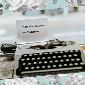 May include: A vintage typewriter with a note on it that says "Follow me on Instagram @ArtVaultCreative".