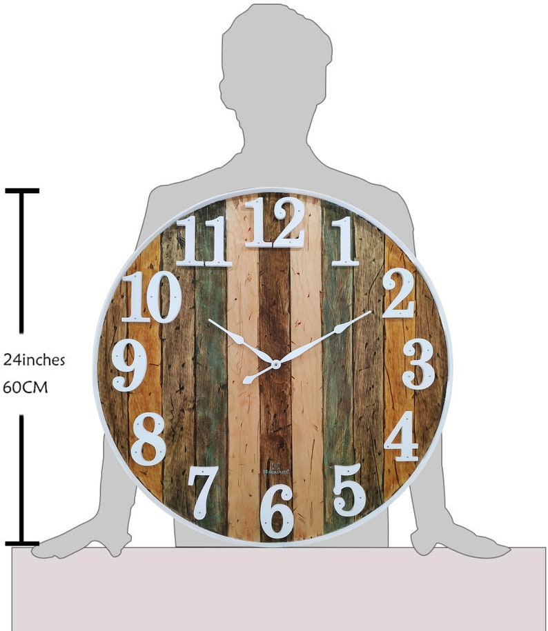 May include: A large, round, 24-inch diameter, wooden wall clock with white Roman numeral markings and a white frame. The clock face has a distressed wood design with a variety of wood tones, including brown, tan, and green.