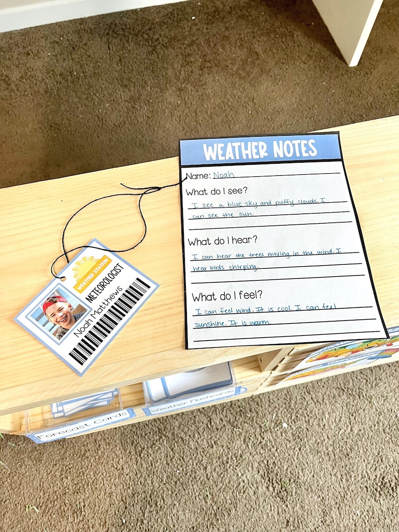 May include: A weather-themed educational set featuring a "Weather Notes" sheet and a "Meteorologist" ID tag. The ID tag displays a photo and the name "Noah Matthews." The notes sheet has prompts about observations and feelings related to weather.