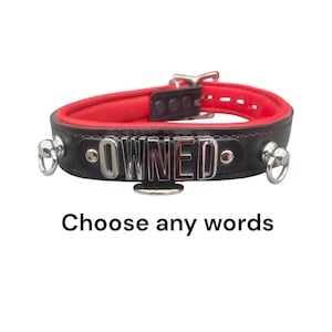May include: A black leather collar with a vibrant red interior lining, featuring silver-toned metal hardware, two side rings, and a central plate displaying the word OWNED in raised silver letters. The text Choose any words is below.