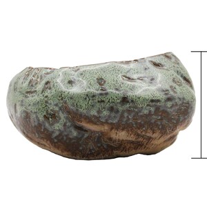 Glazed ceramic succulent pot in copper patina green color.  The unique uneven surface makes the pot look like a stone.  Perfect for succulents, cacti, or small house plants.  Drainage hole at the bottom. 5 inches long, 4.5 inch wide, 2.75" tall