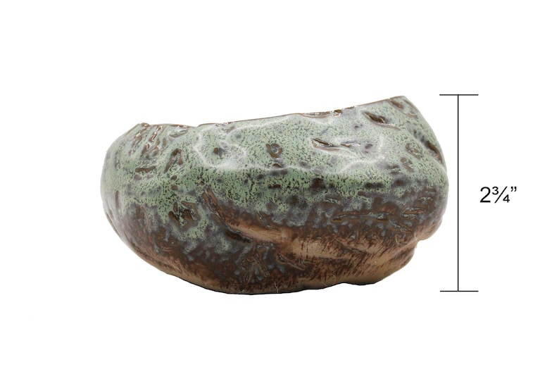 Glazed ceramic succulent pot in copper patina green color.  The unique uneven surface makes the pot look like a stone.  Perfect for succulents, cacti, or small house plants.  Drainage hole at the bottom. 5 inches long, 4.5 inch wide, 2.75" tall