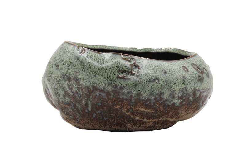 Glazed ceramic succulent pot in copper patina green color.  The unique uneven surface makes the pot look like a stone.  Perfect for succulents, cacti, or small house plants.  Drainage hole at the bottom.