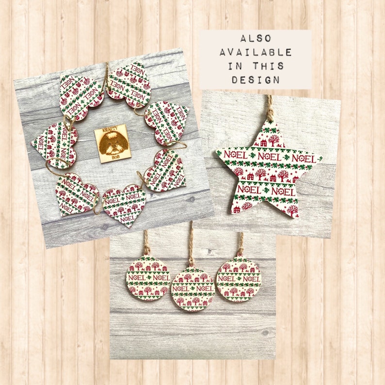 May include: A collection of wooden holiday ornaments featuring heart, star, and circular shapes with a repeating pattern of red and green trees, houses, and the text NOEL. Each piece includes a jute twine hanger. Text reads ALSO AVAILABLE IN THIS DESIGN.