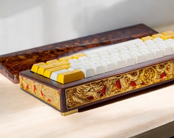 May include: A custom keyboard with white keycaps and yellow accent keys. The keyboard is encased in a dark wood frame with gold and red dragon designs.