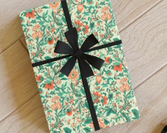 May include: A gift wrapped in green and orange floral patterned paper with a black satin ribbon tied in a bow.