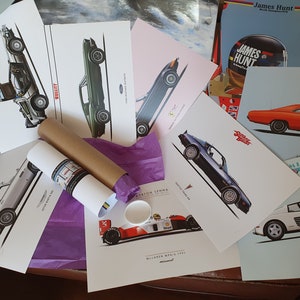 May include: A collection of vintage car posters featuring iconic vehicles like the DeLorean time machine from Back to the Future, a Ford Mustang, a Ferrari Testarossa, and a Dodge Charger. The posters are printed on white paper and have a minimalist design.