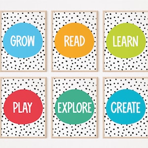 May include: Six framed prints with black polka dots on a white background. Each print features a colorful circle with a different word in white: GROW, READ, LEARN, PLAY, EXPLORE, CREATE.