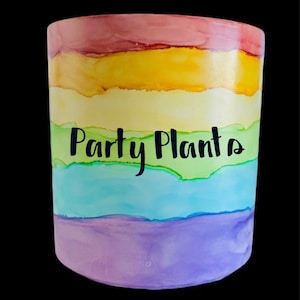 May include: A rainbow-coloured ceramic planter with the words "Party Plants" written in black.