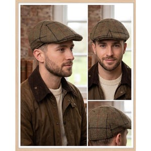 May include: A flat cap featuring a textured olive green wool fabric with a subtle brown and red plaid pattern. The cap has a rounded crown and a short, stiff brim, showcasing a classic construction with visible stitching details across the surface.