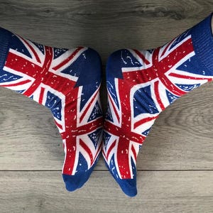May include: A pair of blue socks with a red, white, and blue Union Jack design.