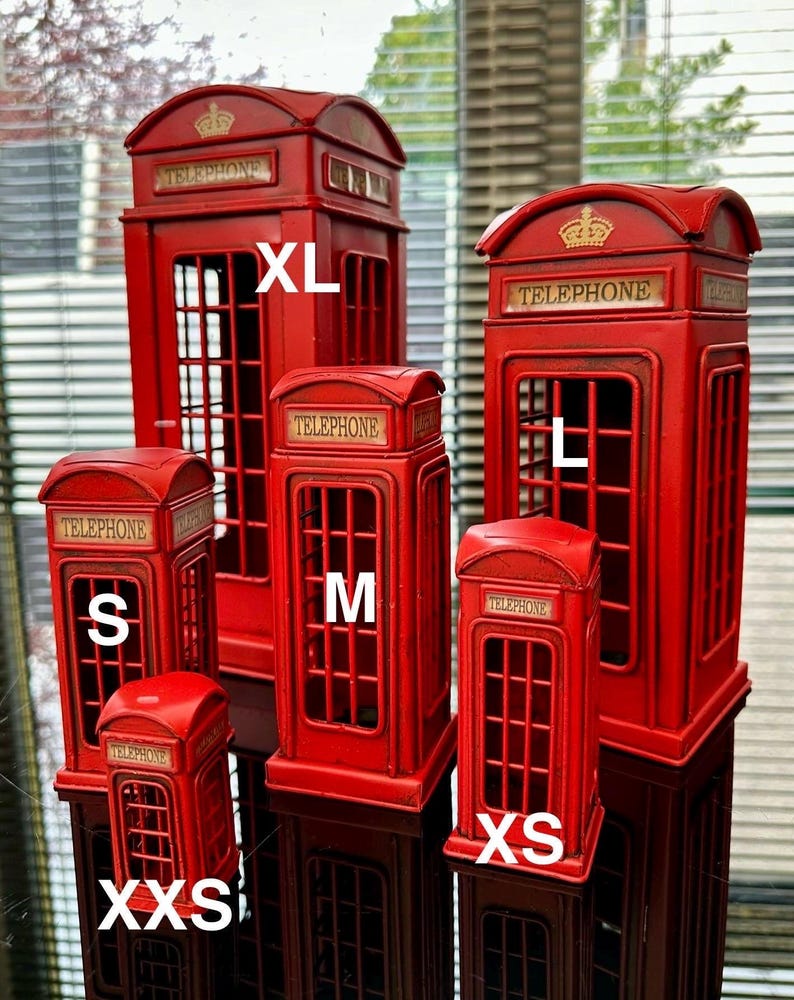 May include: Five red metal miniature telephone boxes in different sizes, labelled with the letters 'XL', 'L', 'M', 'S', and 'XS'.