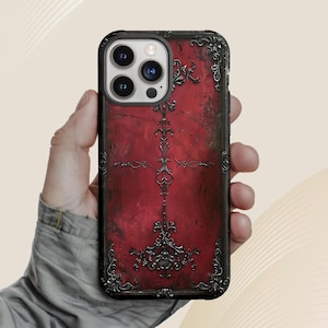 Funda para teléfono con fondo gótico con superficie carmesí y marco de metal intrincado. Diseño elegante y oscuro. Funda gótica.