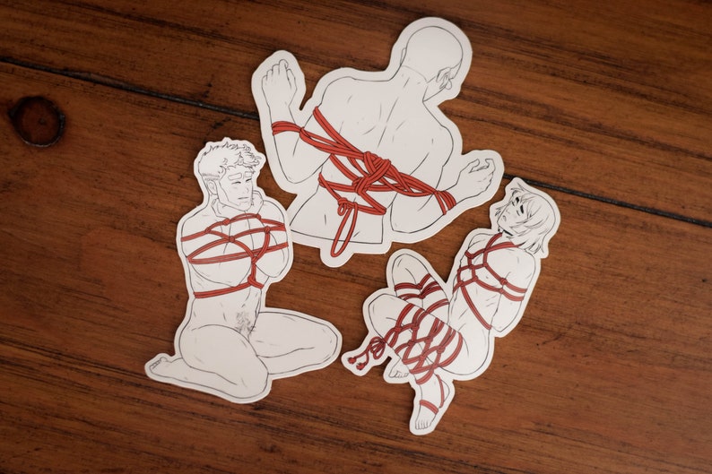 May include: Three white stickers with line drawings of people tied up with red rope. The people are in different poses.
