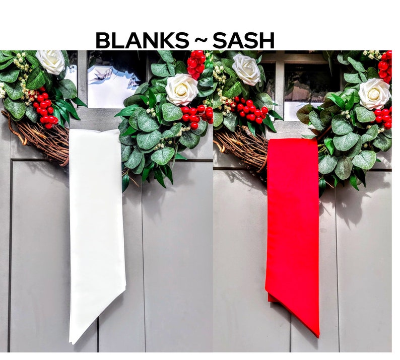 May include: The image features two blank sashes, one white and one red, hanging against a gray background. The sashes are positioned in front of a decorative wreath with white roses, red berries, and green foliage. The text "BLANKS ~ SASH" is at the top.