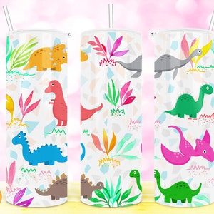 May include: Three stainless steel tumblers with a white background and a colorful dinosaur pattern. The tumblers feature various dinosaurs, including a triceratops, stegosaurus, and brachiosaurus. The dinosaurs are surrounded by colorful foliage and geometric shapes.