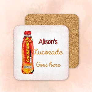 May include: A square cork coaster with a white top surface featuring a graphic of an orange Lucozade energy drink bottle on the left side. The text Alison's Lucozade Goes here is printed in dark red and orange script on the white surface.