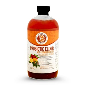 May include: A glass bottle of probiotic elixir with kombucha tea, cranberry and lemon. The bottle is orange and red with white text that reads "Probiotic Elixir with Kombucha Tea Cranberry Lemon" and "Over 20 strains of probiotics".
