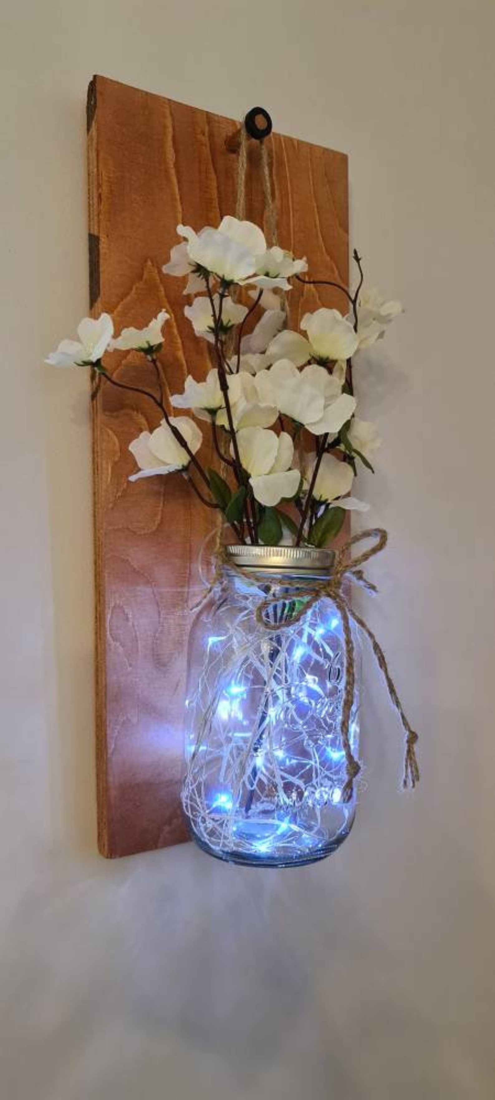 Handmade Mason jar with fairy lights and flowers on a wall Etsy