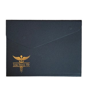 May include: A black folder with a gold medical symbol and the text "LISA PRICE MD".