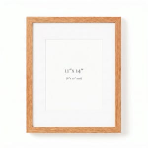 May include: A rectangular wooden picture frame with a white mount. The frame is 28 cm x 36 cm with a 20 cm x 25 cm mount. The frame is made of light-coloured wood and is against a white background.