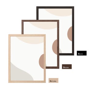 May include: Three framed art prints with abstract designs in neutral colours. The frames are in natural, brown, and black finishes. The artwork features beige, tan, and brown shapes on a white background. The words "BLACK", "BROWN", and "NATURAL" are displayed.
