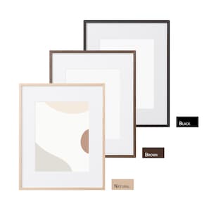 May include: Three framed art prints in black, brown, and natural wood finishes. The artwork features abstract shapes in neutral tones. The frames are square with white matting. The color options are labeled with text: "BLACK", "BROWN", and "NATURAL".