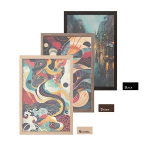May include: Three framed art prints in natural, brown, and black frames. The art features abstract designs with vibrant colors and a cityscape scene. The frames are rectangular and vary in size, showcasing a variety of artistic styles.