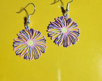 May include: A pair of silver dangle earrings with a purple, pink, and yellow flower design.
