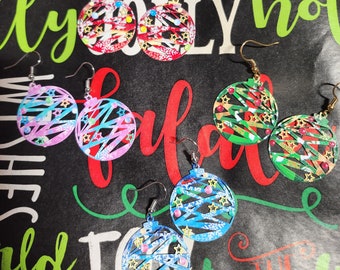 May include: A set of six Christmas ornament earrings. The earrings are made of metal and feature a variety of colors and patterns, including red, green, blue, pink, and white. The ornaments are decorated with stars and snowflakes.