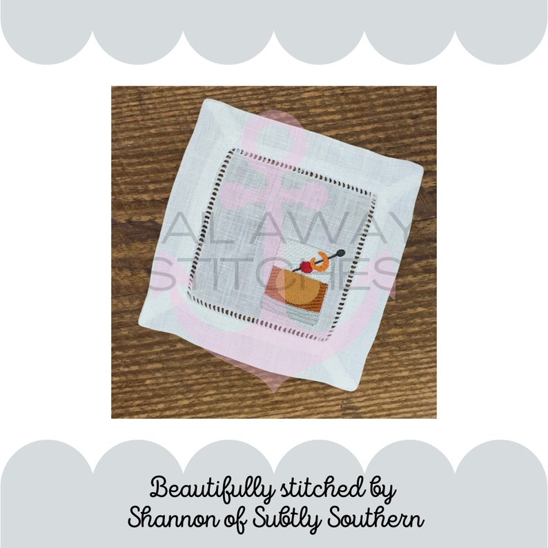 May include: A white linen cocktail napkin with a pink border and a stitched image of a cocktail glass with a cherry and an orange slice. The text "Always Stitches" is embroidered on the napkin.