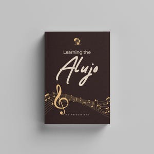 May include: A dark brown book titled Learning the Alujo with a gold treble clef and musical staff lines printed on the cover. The cover features a small gold logo at the top and the text ML Percussions at the bottom in a clean, sans-serif font.