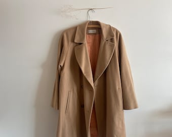 May include: A tan wool coat with a double breasted closure and a label that says "Lauren".